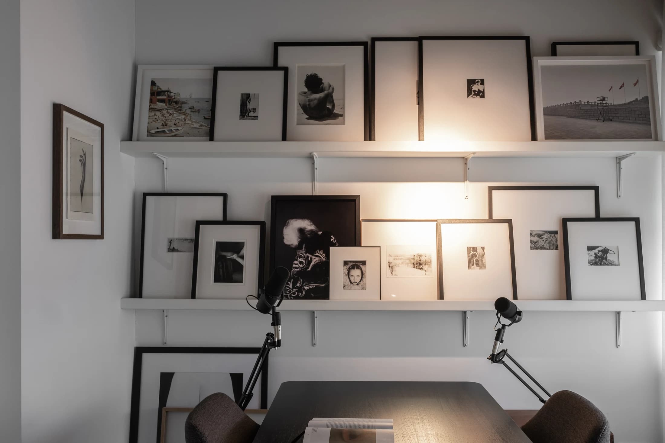 A workspace surrounded by photographs and books