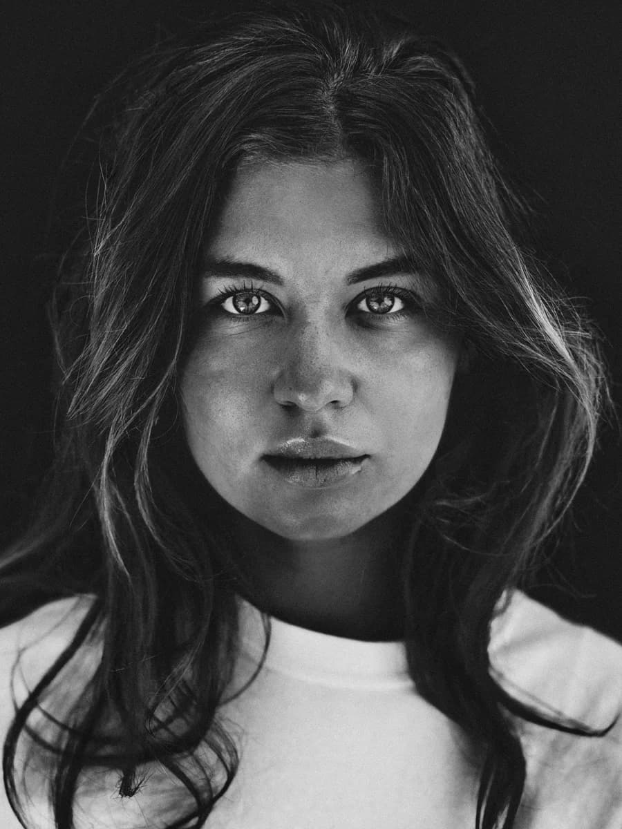Front-facing portrait on a dark background. From Amsterdam Portraits by Bastiaan Woudt.