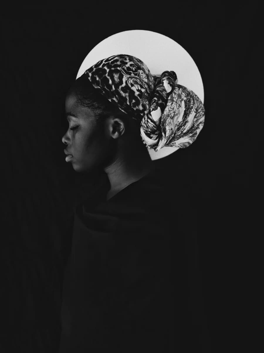 Profile portrait wearing a patterned headwrap. From Champions by Bastiaan Woudt.