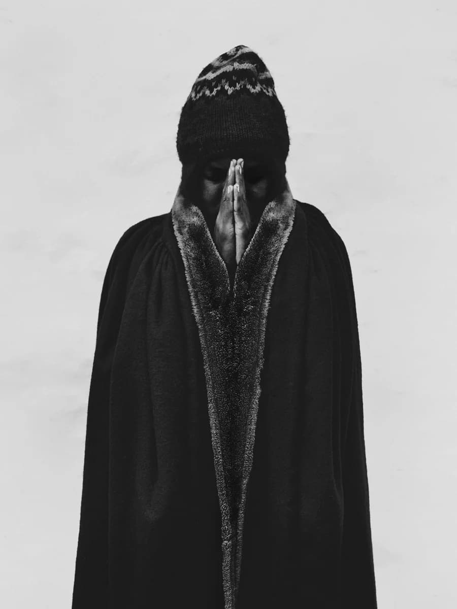 Figure in a dark robe and knitted hat. From Peak by Bastiaan Woudt.