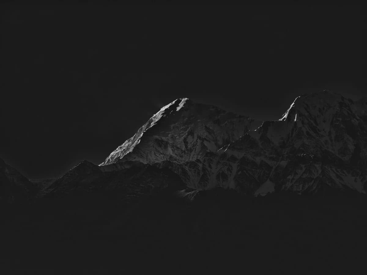 Mountain peaks against a dark sky. From Peak by Bastiaan Woudt.