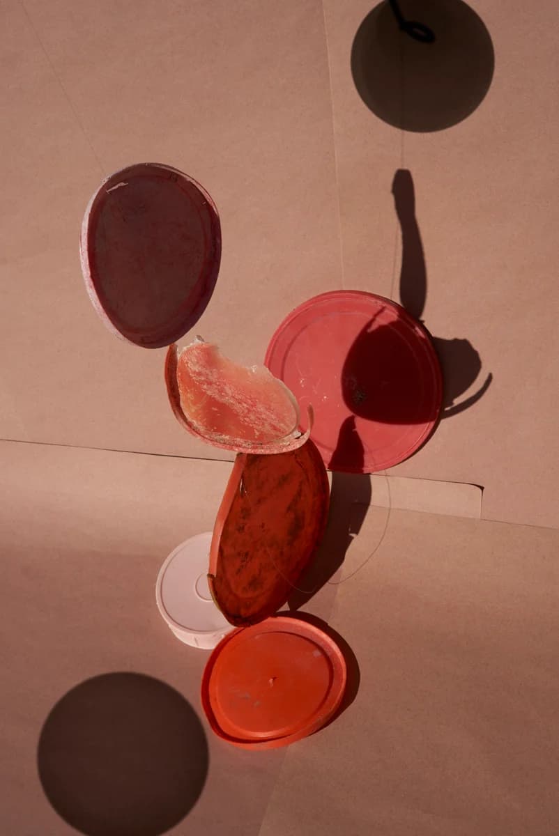 Suspended arrangement of coloured plastic discs. From Plastic Ocean by Thirza Schaap.
